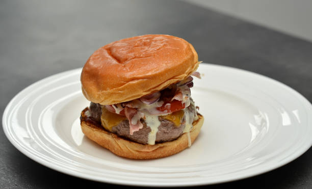 istock one tasty hamburger on white plate photography 641421432