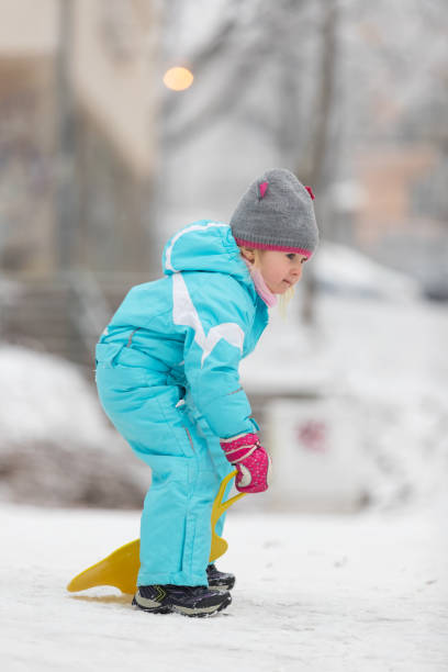 istock Little girl sledding 641421638