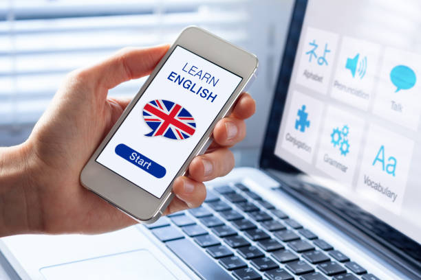 Learn English language online concept, mobile phone, flag of UK Learn English language online concept with a person showing e-learning app on mobile phone with the british flag of the United Kingdom english culture stock pictures, royalty-free photos & images