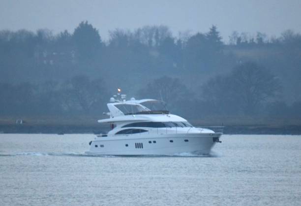 istock yacht boat heading to docks at dusk 641434848
