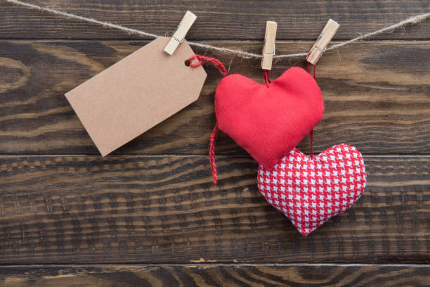 istock Red hearts and blank tag on rope with clothespins 641435138