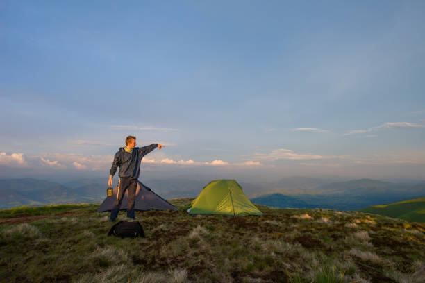 istock Green Camping tent and man 641439052