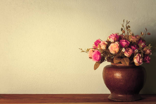 istock Artificial flowers roses in the pot in room 641439120