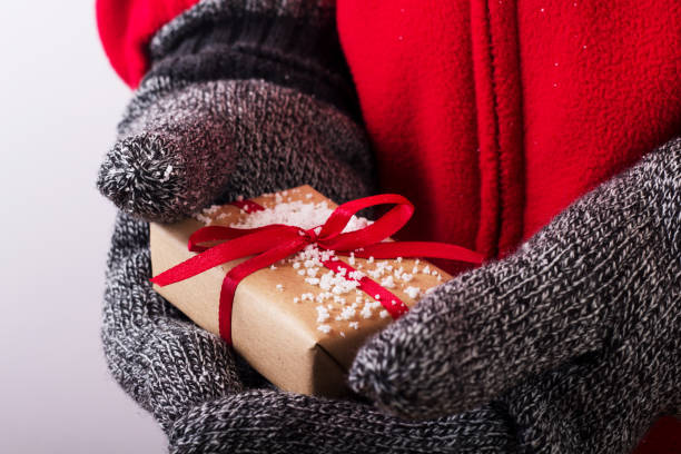 istock Open hands holding a present wrapped with a red ribbon 641440064