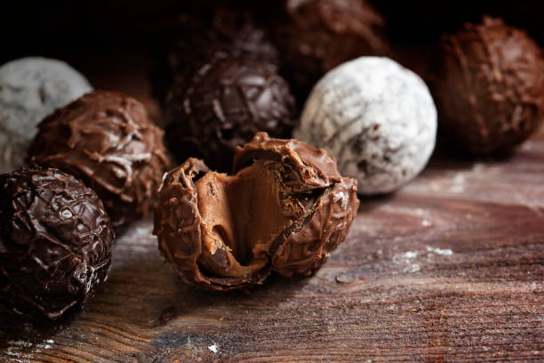 istock Chocolate truffle pralines on dark rustic wood, close up 641441332