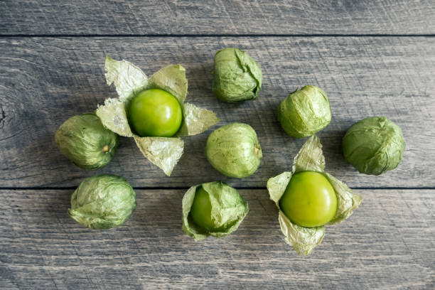 tomatillos group of tomatillos on wooden background tomatillo photos stock pictures, royalty-free photos & images