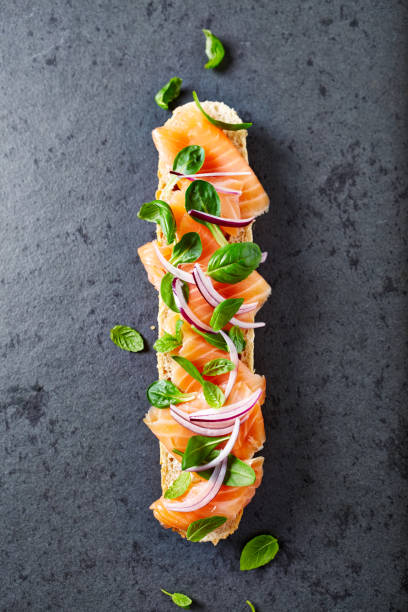 Baguette with organic smoked salmon topped with herbs