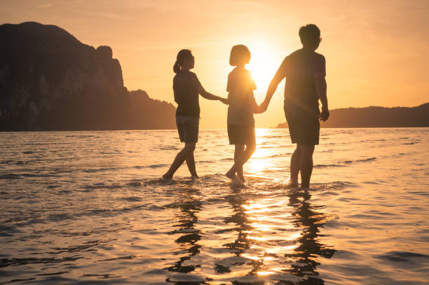 istock happy family walking on the beach 641445058