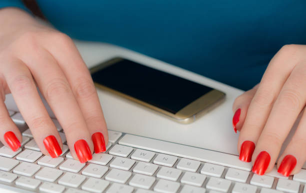 istock Woman working   behind pc with gold phone ready 641447370