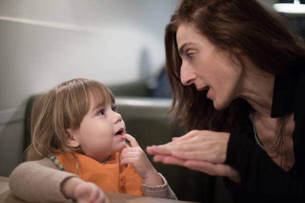 istock woman telling tale to child at restaurant 641448044