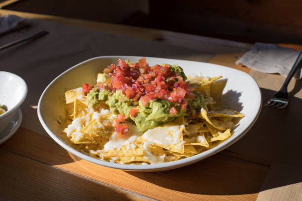 istock nachos with guacamole and cheese on table 641448236