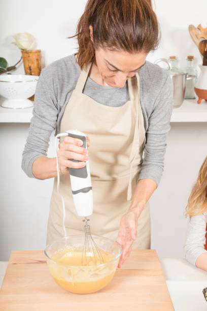 istock woman whipping with electric mixer 641448626