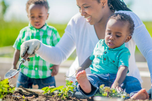 istock Mother Working in the Garden with Her Twins 641448656