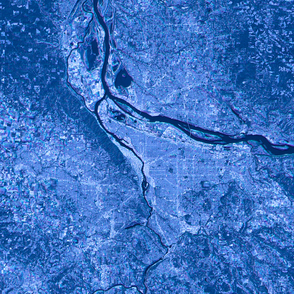 Blue toned Satellite Image of Portland, Oregon, USA. Digital Composite. Contains modified Copernicus Sentinel data (2016) courtesy of ESA. URL of source image: https://scihub.copernicus.eu/dhus/#/home. The source data is in the public domain.