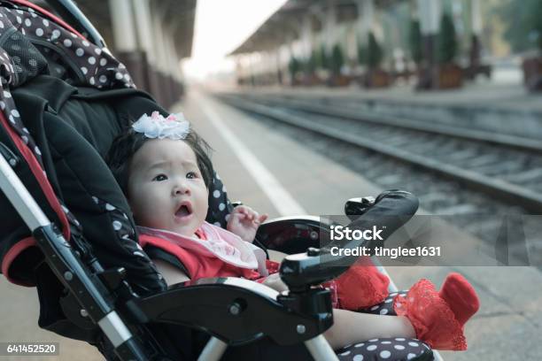 Asian Baby Girl Sitting In Stroller In Railway Station Stock Photo - Download Image Now