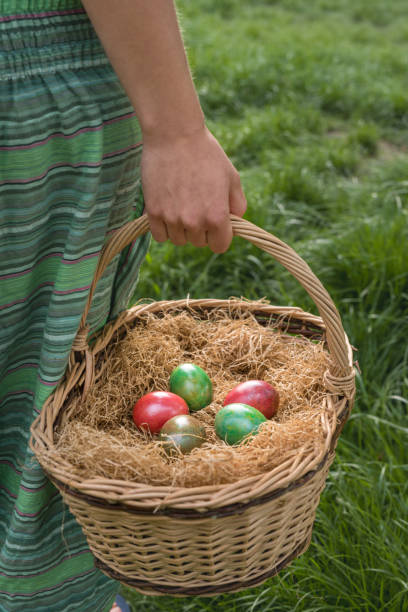 istock Caucasian man holding straw basket filled with colored easter eggs 641453958