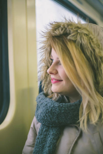 istock woman traveling looking out the window while sitting 641454626