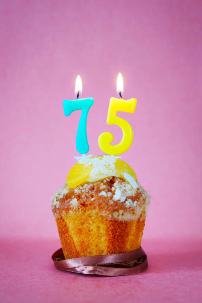 istock Muffin with burning birthday candles as number seventy five 641454754