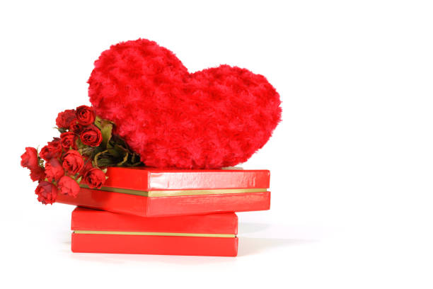 Valentine's day concept : Heart-shaped pillow , roses and red boxes isolated on white background