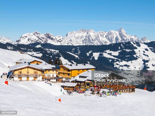 Downhill Slope And Apres Ski Mountain Hut With Restaurant Terrace In Saalbach Hinterglemm Leogang Winter Resort Tirol Austria Europe Sunny Day Shot Stock Photo - Download Image Now