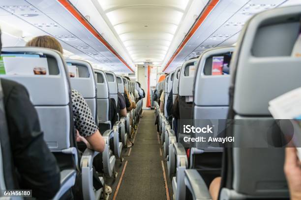Airplane With Passengers On Seats Waiting To Take Off Stock Photo - Download Image Now