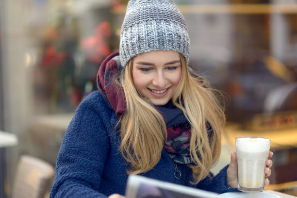 istock woman with coffee and newspaper outside 641457680
