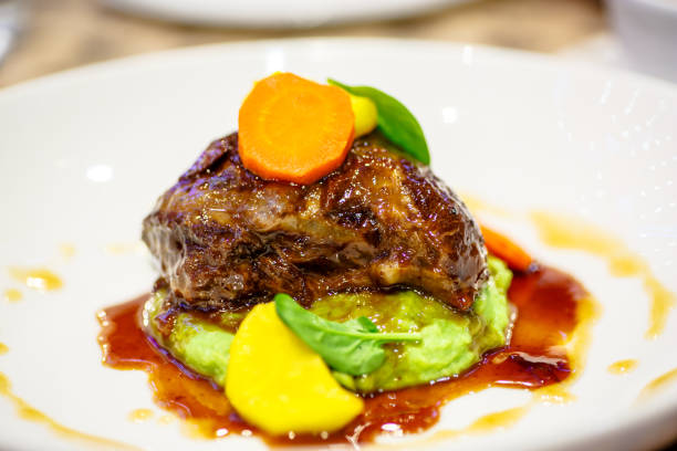 istock Braised beef with carrots lying on a green mashed potatoes with wasabi. 641459844