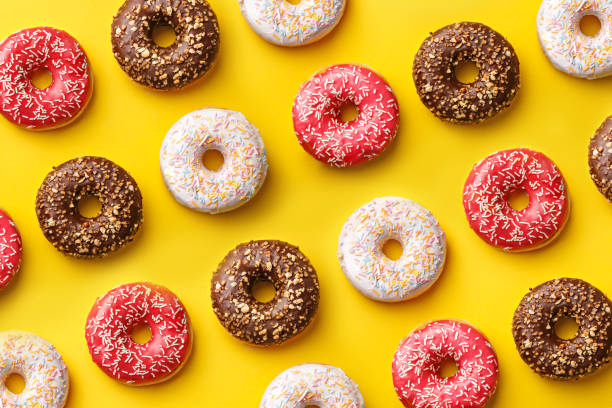 Flat lay donuts pattern on a yellow background. Top view stock photo