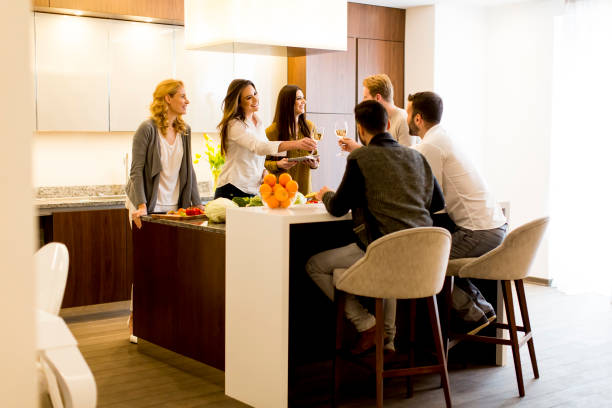 istock Group of young people having meal in the kitchen 641461184