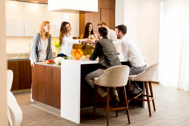 istock Group of young people having meal in the kitchen 641461210