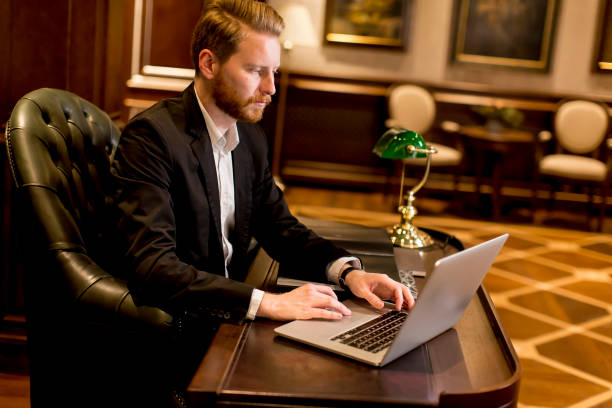 istock Handsome young man with red hair working in the luxury office 641465822