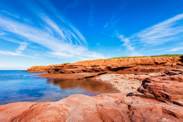 Stock photo of red, rocky coastline in Prince Edward Island National Park, near Cavendish, north coast of PEI, Canada