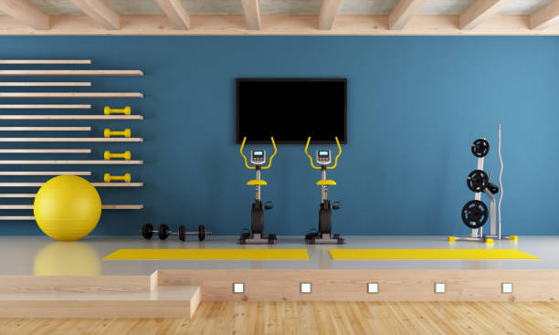 Blue room with gym equipment Blue room with spinning bike, pilates ball and hand weight - 3d rendering-Note: the room does not exist in reality, Property model is not necessary exercise room stock pictures, royalty-free photos & images