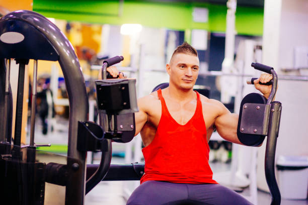 istock Muscular athlete on daily workout in gym, exercising with weights 641471038