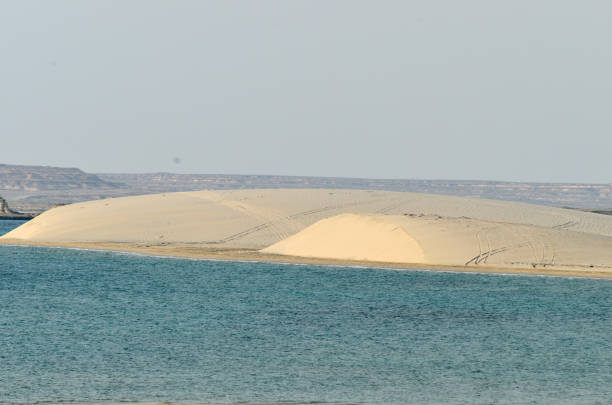 istock Sand dunes descending into the sea 641477014