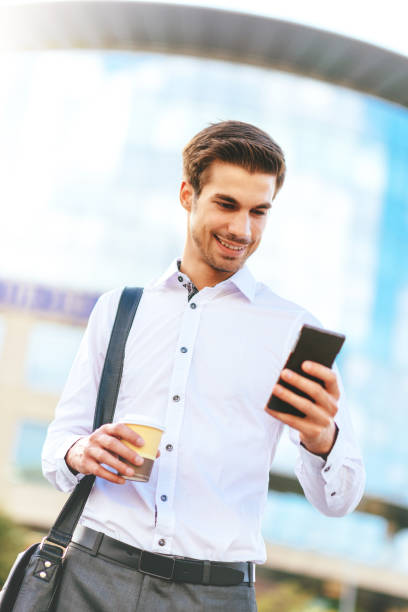 istock Business on the move - businessman in financial district using smartphone for communication 641477962