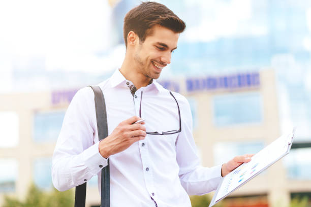 istock Business on the move - businessman in financial district using smartphone for communication 641478332