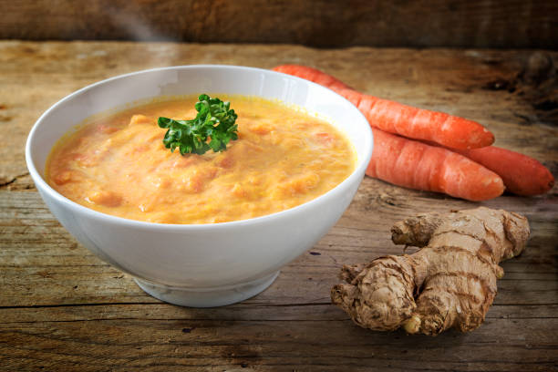 istock Carrot soup with ginger and parsley,  rustic wooden background 641483546