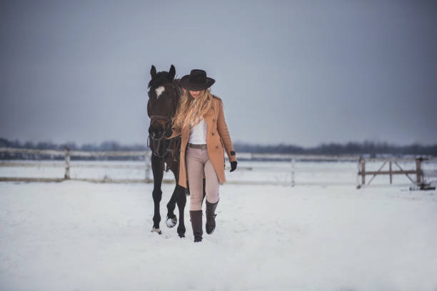 istock Woman enjoying winter breaks with her horse 641485400