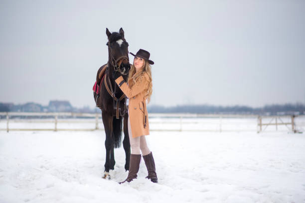 istock Woman enjoying winter breaks with her horse 641485448