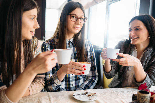 istock Women friends enjoy coffee at cafe 641486244