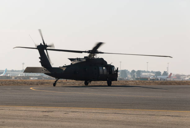 istock Military utility helicopter taking off at dusk 641488570