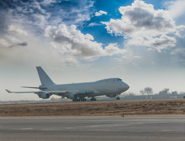 istock Jumbo jet airplane landing on runway 641488598