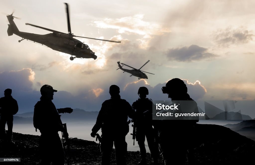 Military Mission at dusk Silhouette of soldiers and helicopters during a military mission at dusk. Afghanistan Stock Photo