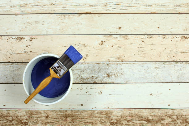 istock Paintbrush on a pot of  blue paint 641489944
