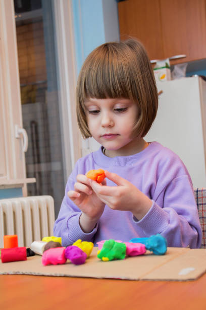 istock Girl playing with play dough - plasticine 641492960