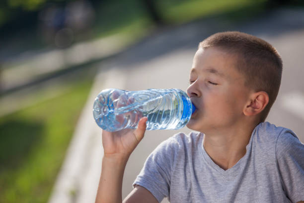 istock Cute teenage boy drinking water after sport training 641493636
