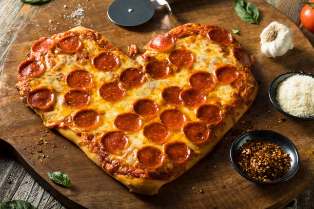 istock Homemade Heart Shaped Pepperoni Pizza 641500942