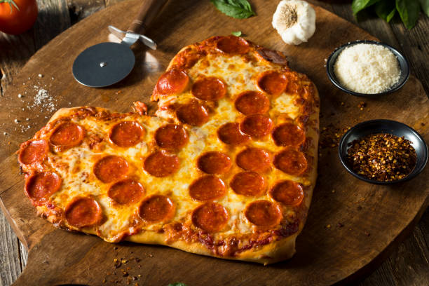istock Homemade Heart Shaped Pepperoni Pizza 641501112