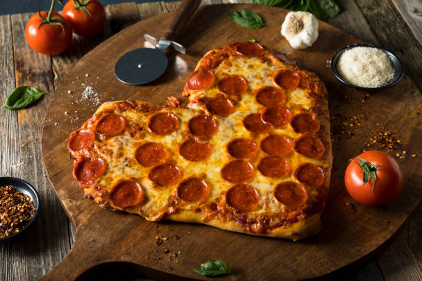 istock Homemade Heart Shaped Pepperoni Pizza 641501268